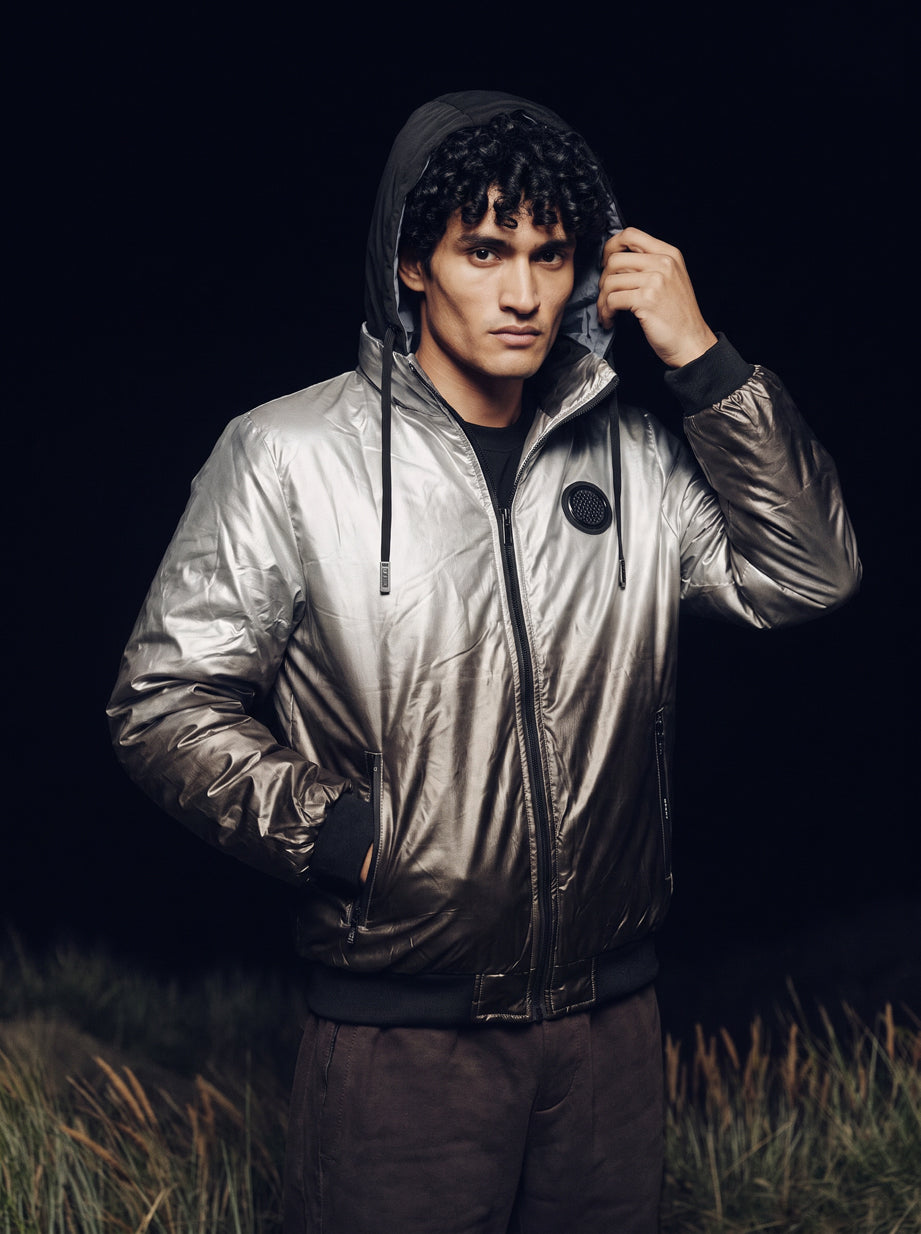 Reversible Chrome Puffer Jacket in silver, worn with the hood up