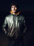 Reversible Chrome Puffer Jacket in green, front view on model showing the yellow hood lining