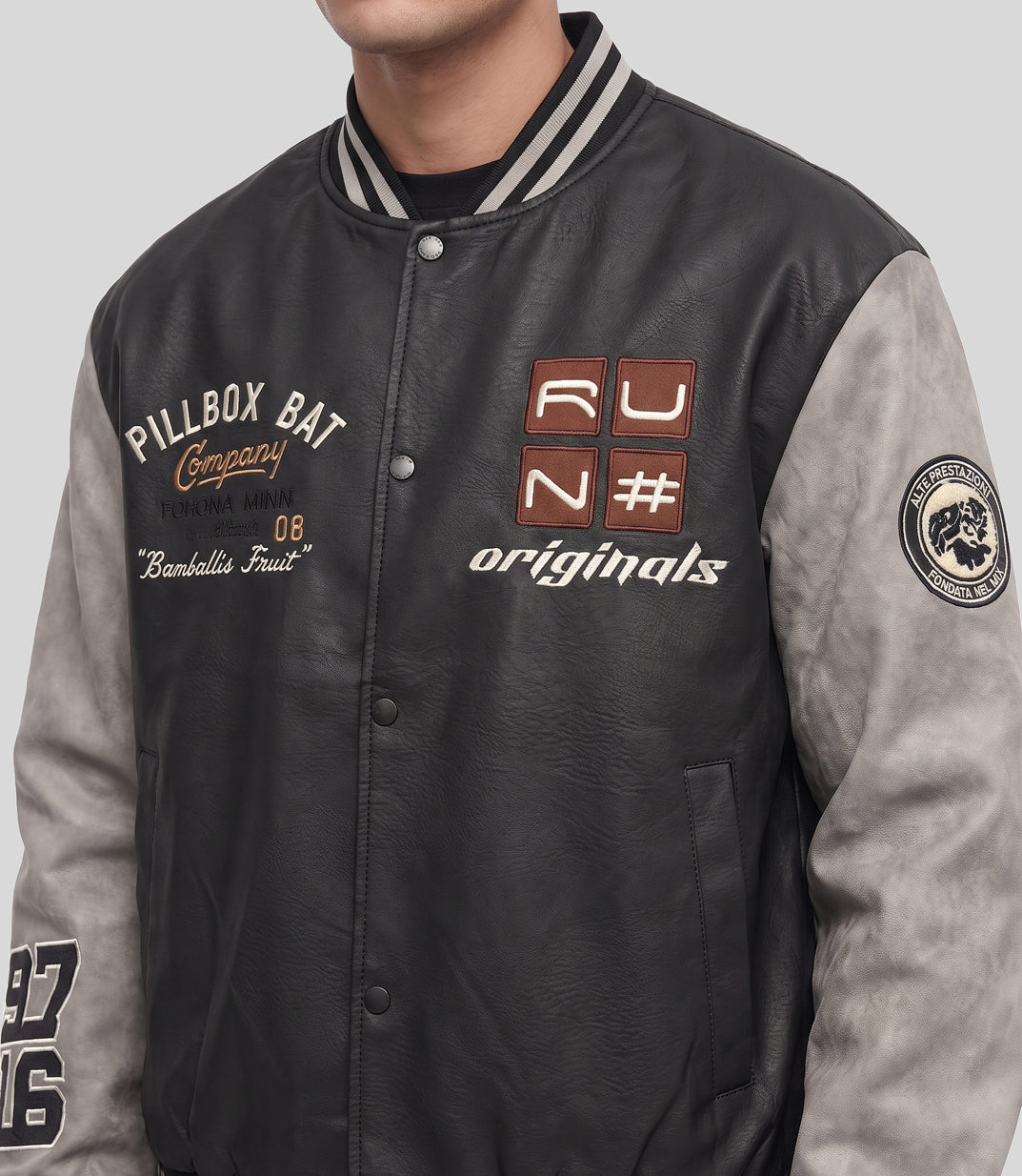 Varsity Bomber Jacket in black, close-up of the embroidered patches