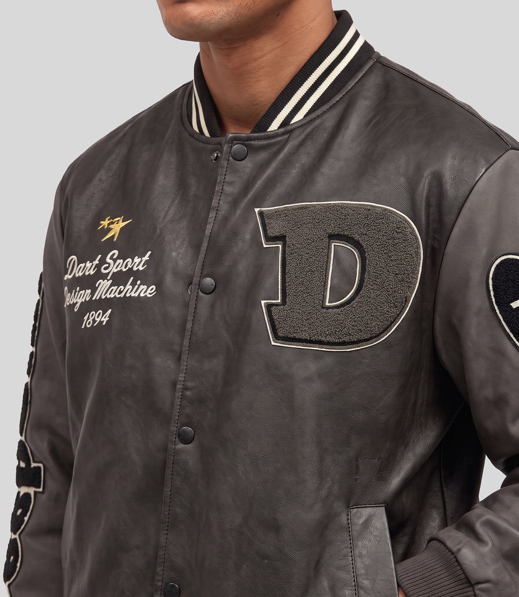 Stone Wash Varsity Jacket in charcoal, close-up of the embroidered chest patches