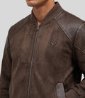 Heritage Suede Bomber Jacket in brown, close-up of the ribbed collar and leather shoulder panel