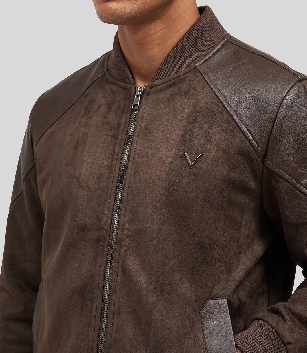 Heritage Suede Bomber Jacket in brown, close-up of the ribbed collar and leather shoulder panel